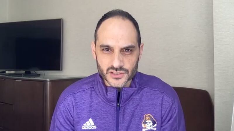 New ECU head men's basketball coach Michael Schwartz in Pirates gear