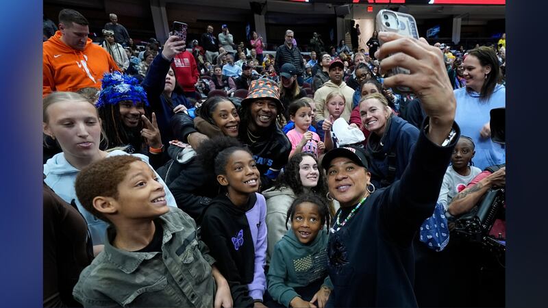 South Carolina head coach Dawn Staley takes a selfie with fans during practice for the NCAA...