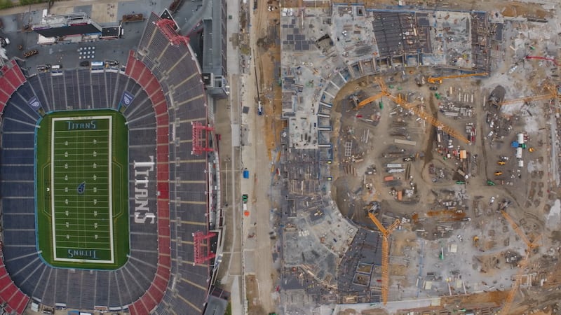 Drone video shows the walls around the field starting to form as four massive cranes helping...
