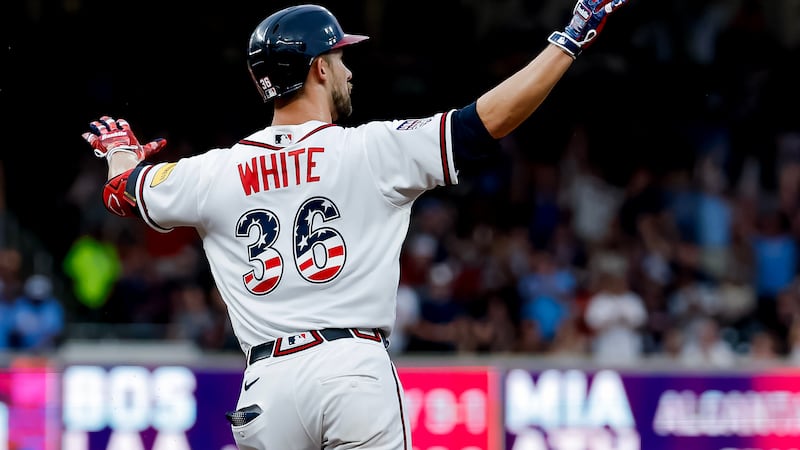 Atlanta Braves' Eli White reacts while rounding the bases after hitting solo home run against...