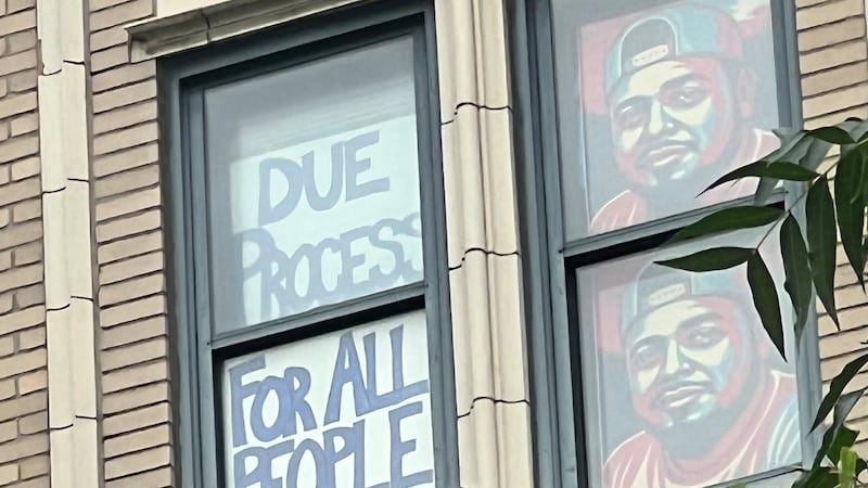 Windows across from the downtown Nashville federal courthouse show support for Kilmar Abrego...