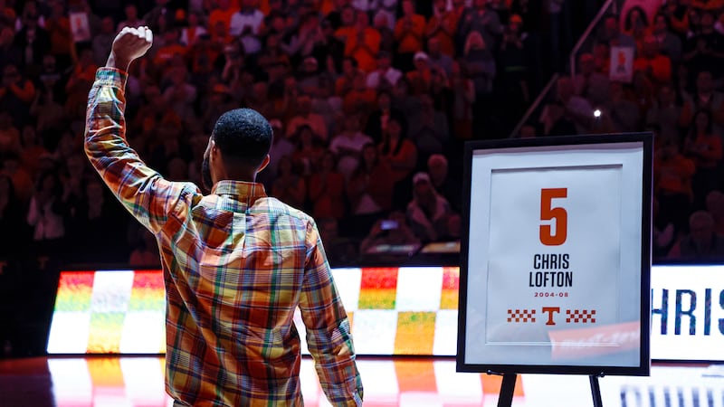 Former Tennessee player Chris Lofton acknowledges fans during halftime of an NCAA college...