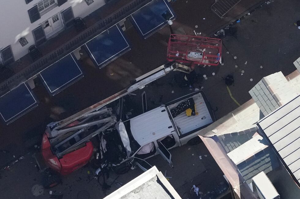 Investigators work the scene Wednesday (Jan. 1) after a man drove a truck into a crowd of New...