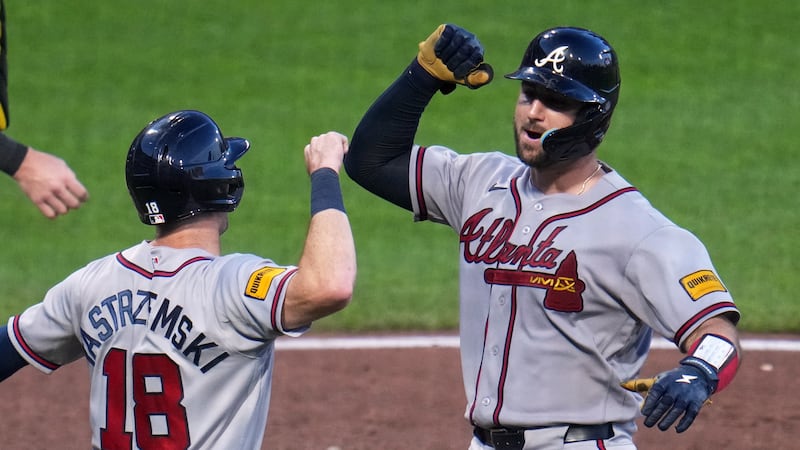 Atlanta Braves' Joey Bart, right, celebrates with Mike Yastrzemski as he returns to the dugout...