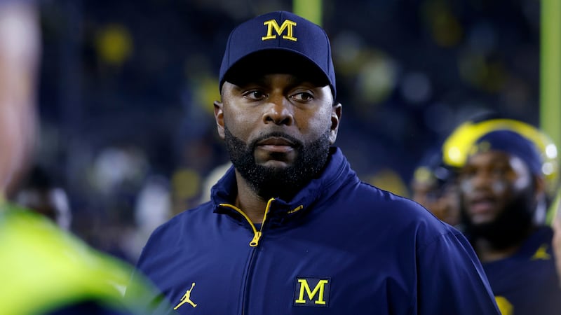 Michigan coach Sherrone Moore walks off the field following an NCAA football game on Saturday,...